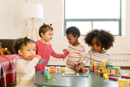 children-playing-daycare Young children playing with blocks at a daycare.